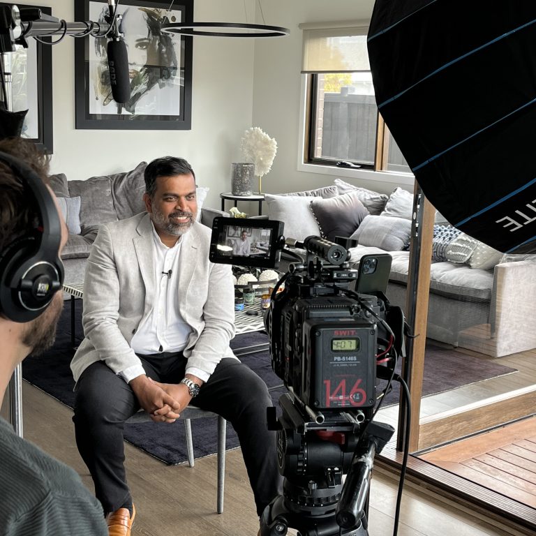 Light & Glo co-founder being interviewed on camera in a professionally lit setup, discussing brand storytelling and the impact of scent marketing in modern retail environments.
